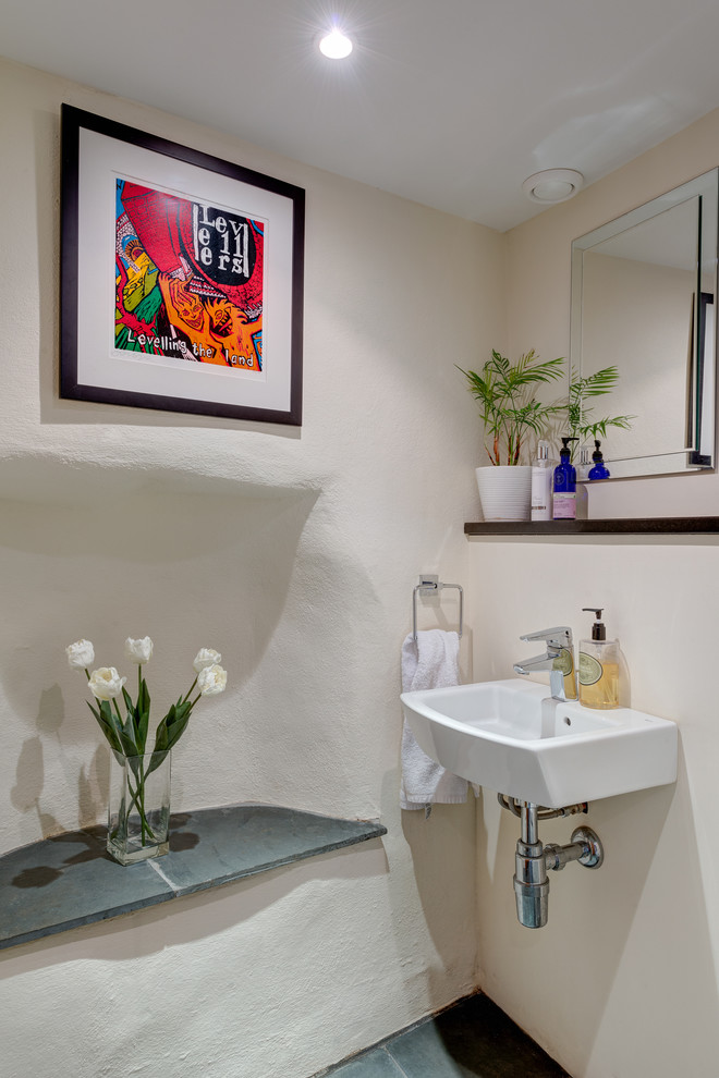 Design ideas for a small mediterranean cloakroom in Devon with a wall-mounted sink, white walls and slate flooring.