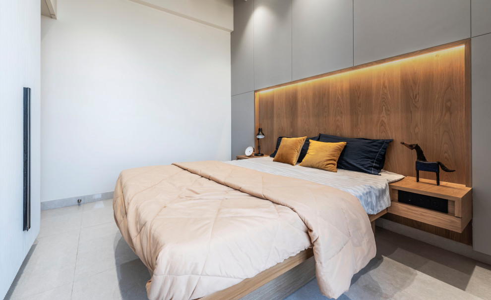 Immagine di una camera da letto design con pareti bianche e pavimento grigio