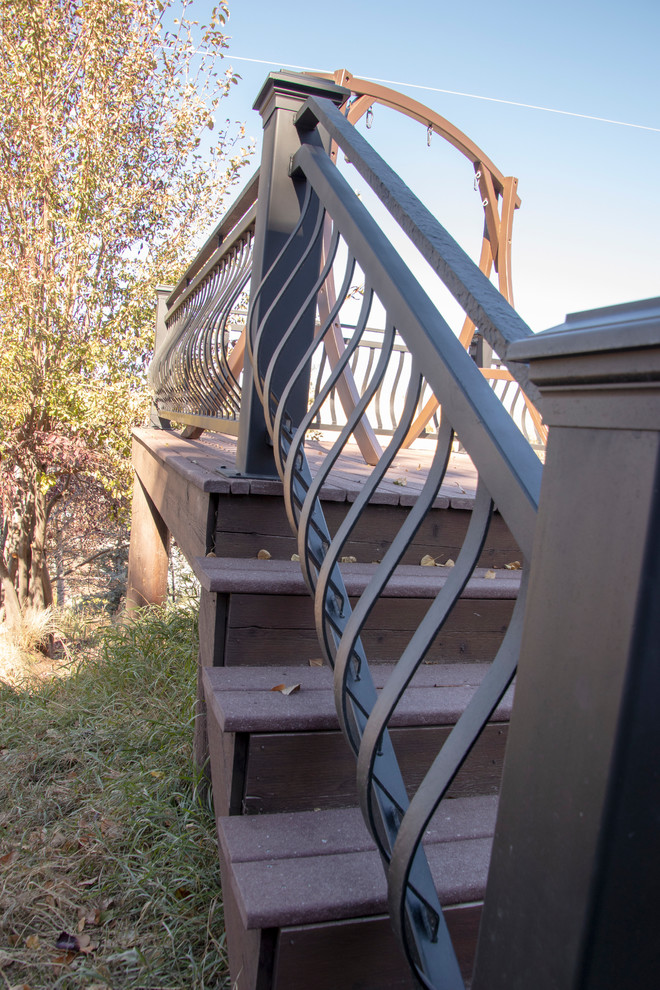 Example of a large mountain style backyard deck design with no cover