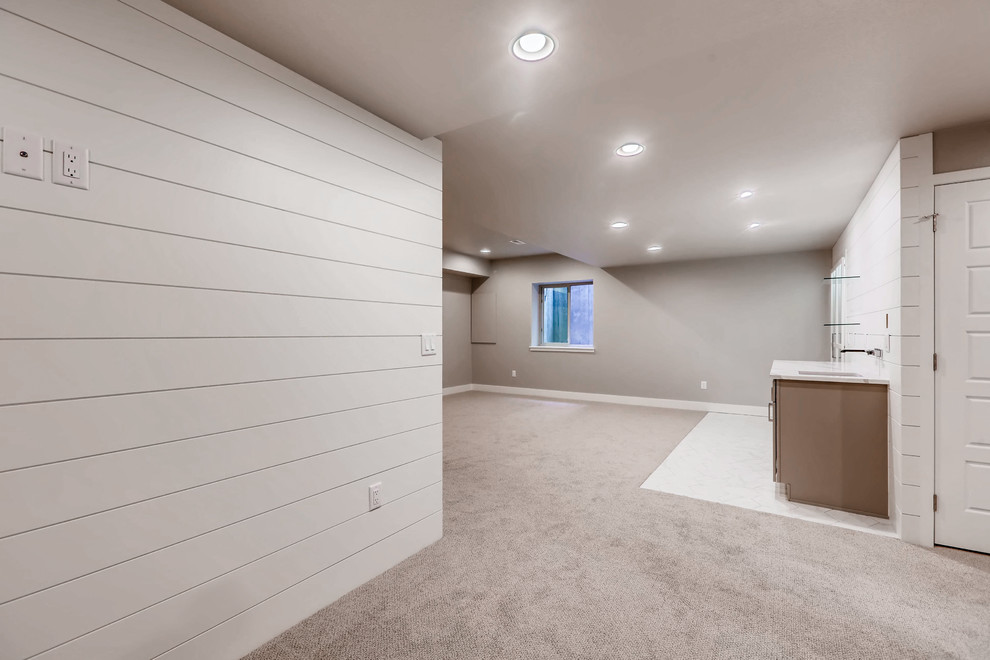 Design ideas for a large country fully buried basement in Denver with beige walls, carpet, no fireplace and beige floor.