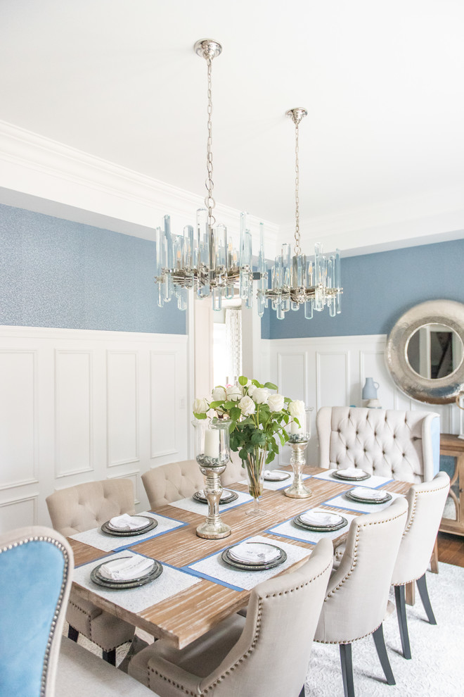 Example of a large transitional medium tone wood floor and brown floor enclosed dining room design in Toronto with blue walls and no fireplace