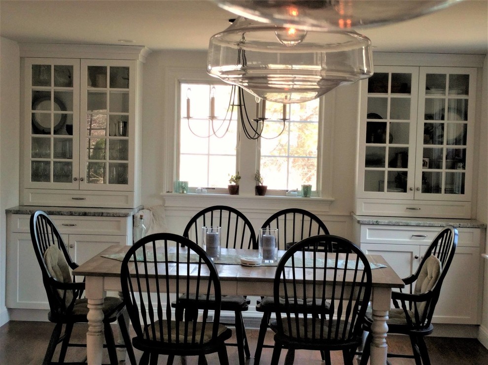 Example of a mid-sized transitional dark wood floor and brown floor great room design in Boston with white walls and no fireplace