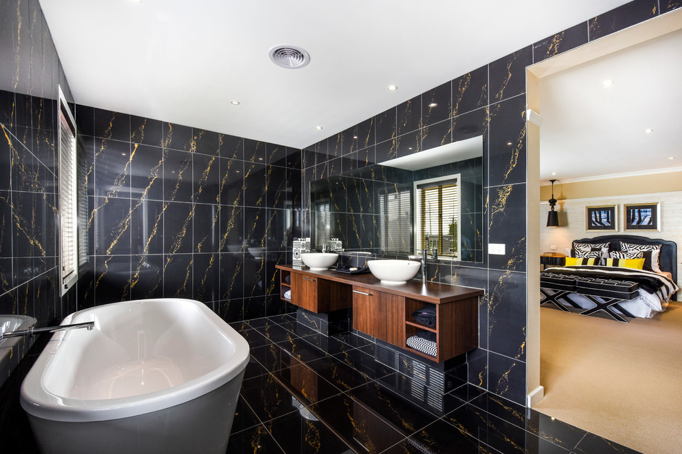 Photo of a contemporary master bathroom in Melbourne with flat-panel cabinets, dark wood cabinets, a freestanding tub, multi-coloured tile and a vessel sink.