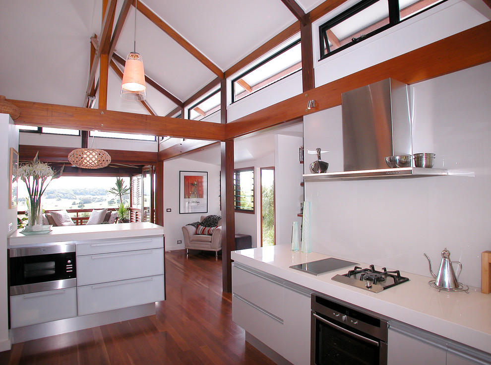 Contemporary kitchen in Brisbane with flat-panel cabinets, white cabinets and stainless steel appliances.