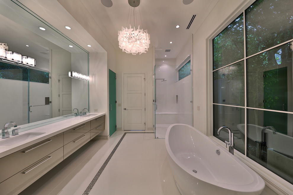 Inspiration for a large contemporary master bathroom in Los Angeles with flat-panel cabinets, beige cabinets, a freestanding tub, a corner shower, a two-piece toilet, white tile, porcelain tile, white walls, porcelain floors, a drop-in sink, quartzite benchtops, white floor, a hinged shower door and white benchtops.