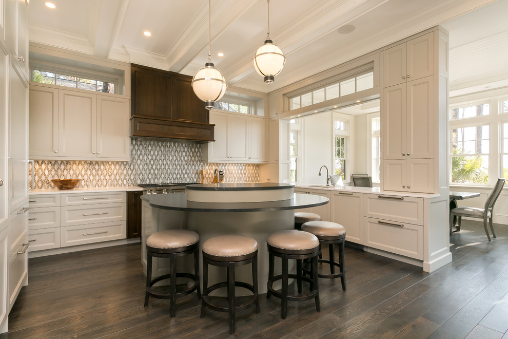 Design ideas for a large beach style u-shaped kitchen in Charleston with a drop-in sink, white cabinets, marble benchtops, cement tile splashback, stainless steel appliances, dark hardwood floors, with island, white benchtop, shaker cabinets, multi-coloured splashback and brown floor.