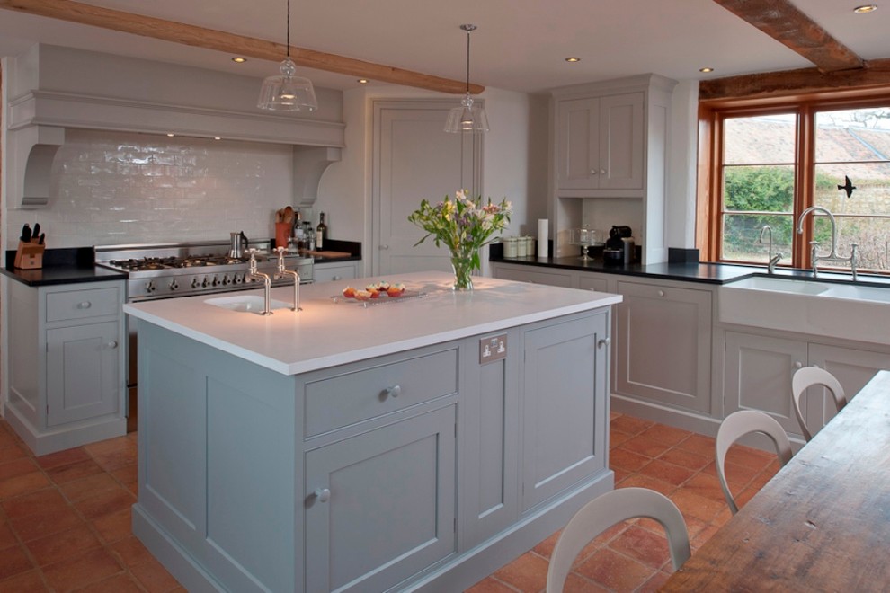 Photo of a country kitchen in Kent with beaded inset cabinets, a farmhouse sink, quartz benchtops, blue cabinets, white splashback and subway tile splashback.
