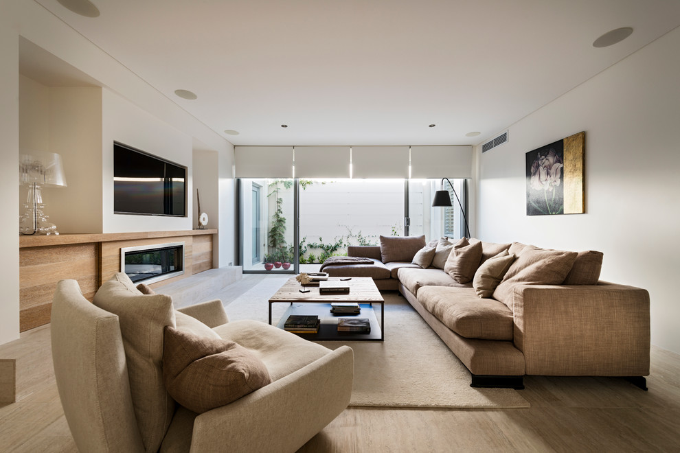 Large contemporary open concept living room in Perth with white walls, light hardwood floors, a ribbon fireplace and a built-in media wall.