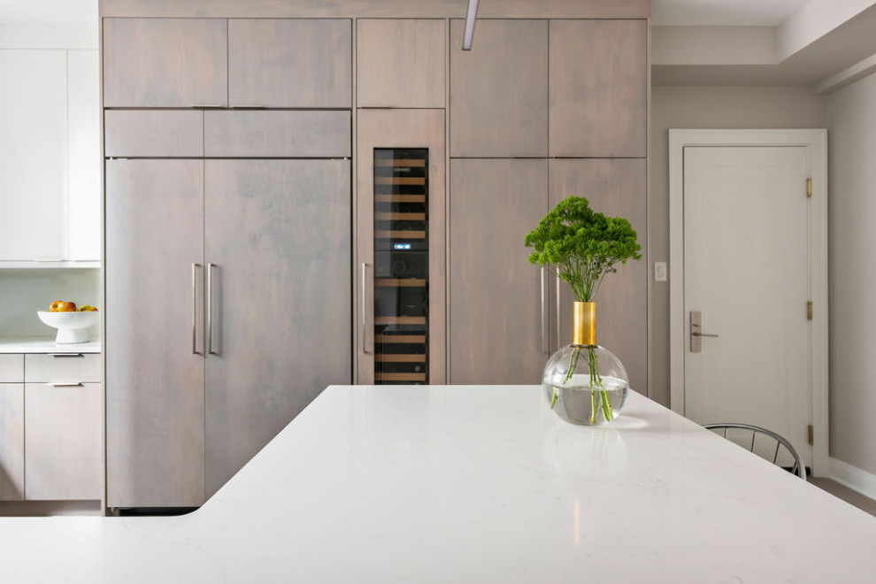 Inspiration for a medium sized modern u-shaped kitchen/diner in Chicago with a built-in sink, flat-panel cabinets, medium wood cabinets, engineered stone countertops, white splashback, stainless steel appliances, limestone flooring, an island, beige floors and white worktops.