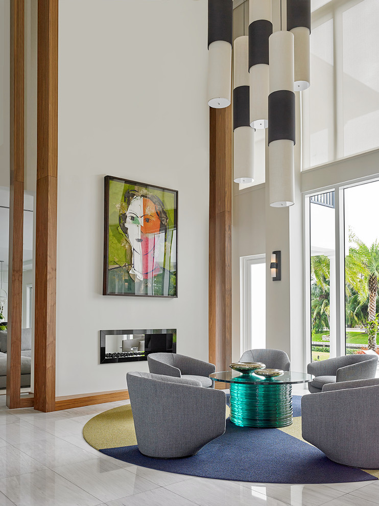 Photo of a contemporary formal living room in Miami with white walls, a two-sided fireplace, no tv and grey floor.