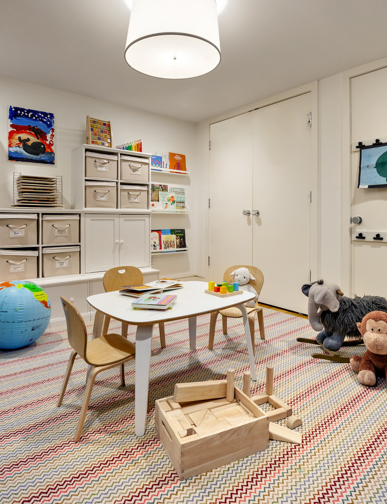 This is an example of a scandinavian kids' playroom in New York with white walls.