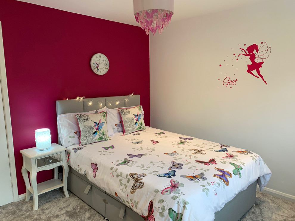 Design ideas for a mid-sized modern bedroom in Hertfordshire with pink walls, carpet and grey floor.