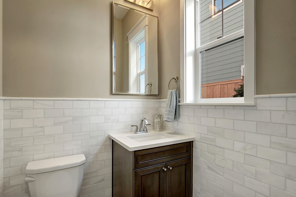 Design ideas for an arts and crafts powder room in Seattle with beaded inset cabinets, dark wood cabinets, white tile, ceramic tile, grey walls, an undermount sink and engineered quartz benchtops.
