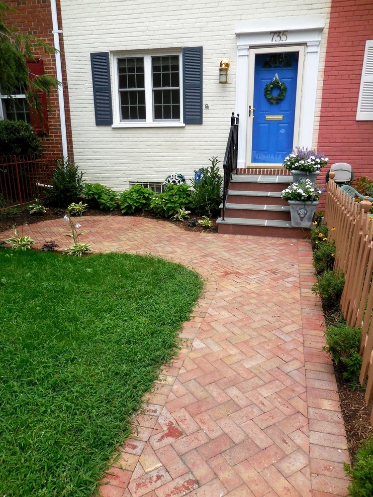 Inspiration for a small traditional front yard partial sun garden in DC Metro with a garden path and brick pavers.