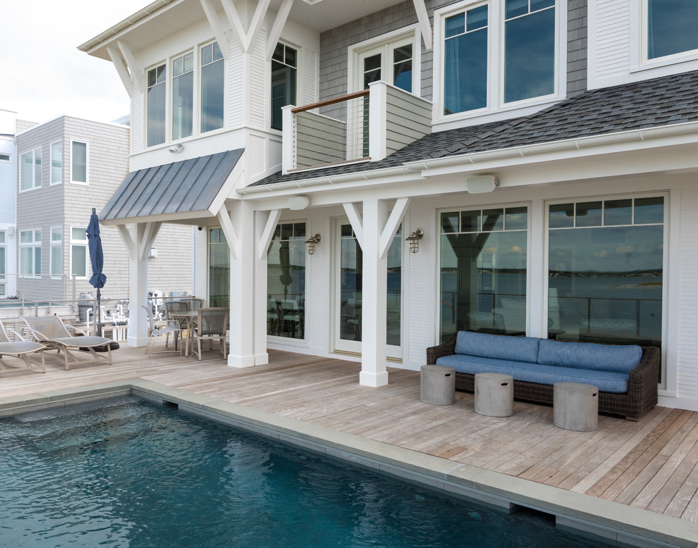 Inspiration for a small beach style backyard rectangular aboveground pool in New York with a hot tub and decking.