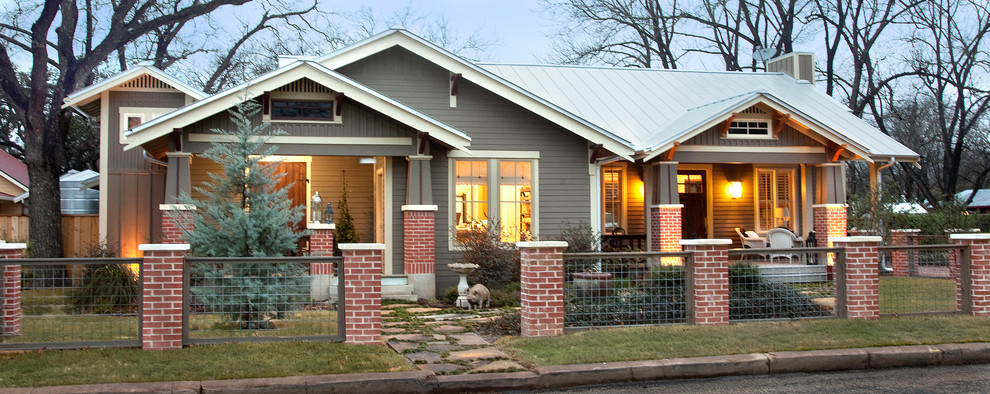 Photo of a mid-sized arts and crafts one-storey brown house exterior in Austin with concrete fiberboard siding, a gable roof and a metal roof.