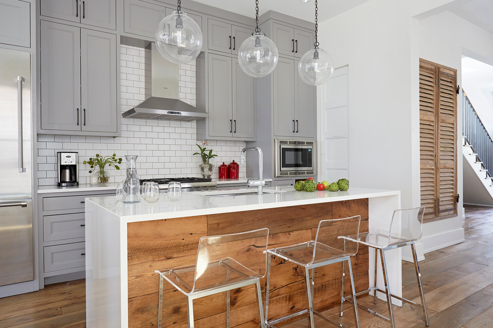 Transitional galley dark wood floor kitchen photo in Richmond with an undermount sink, shaker cabinets, gray cabinets, white backsplash and an island
