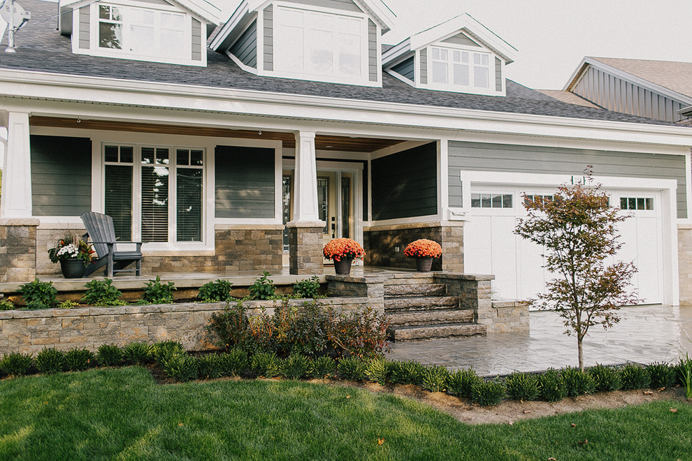 Photo of a mid-sized traditional front yard partial sun garden in Toronto with a container garden and natural stone pavers.