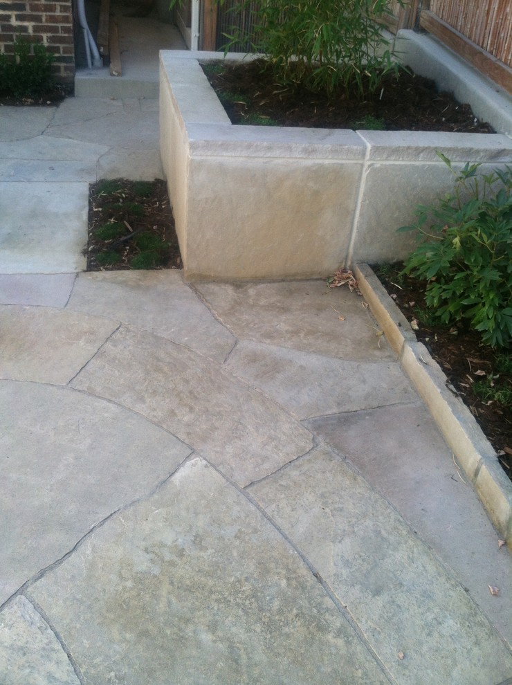 Design ideas for a small asian backyard patio in Denver with natural stone pavers.