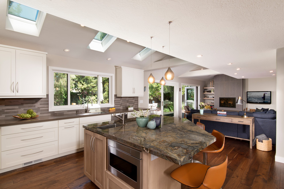 Inspiration for an expansive transitional l-shaped eat-in kitchen in San Francisco with an undermount sink, shaker cabinets, brown splashback, stainless steel appliances, medium hardwood floors, with island, brown floor, brown benchtop, vaulted, brown cabinets, granite benchtops and matchstick tile splashback.