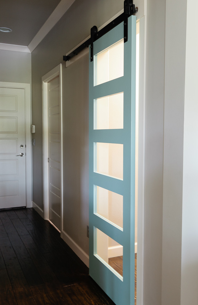 Example of a mid-sized beach style dark wood floor hallway design with blue walls