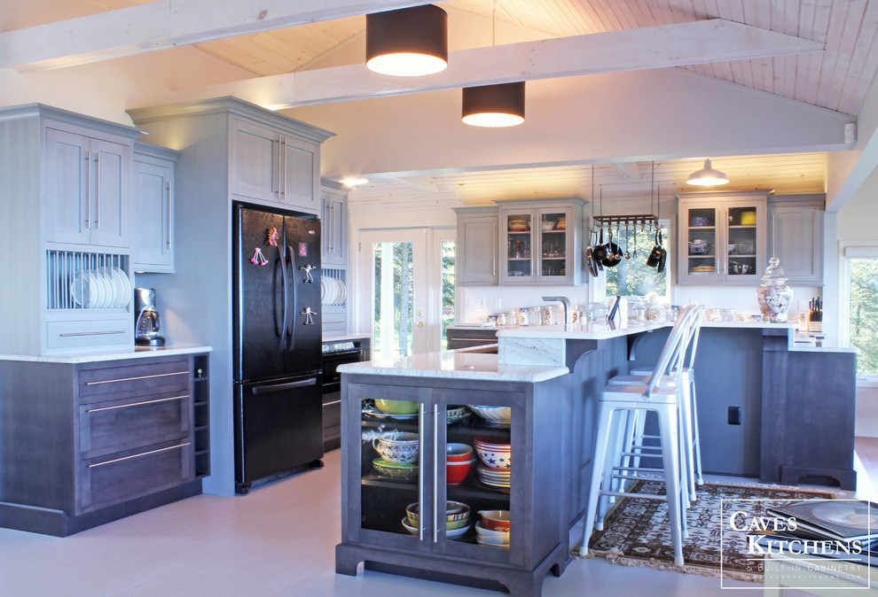 Expansive beach style l-shaped open plan kitchen in New York with an undermount sink, recessed-panel cabinets, grey cabinets, granite benchtops, white splashback, black appliances, painted wood floors and with island.
