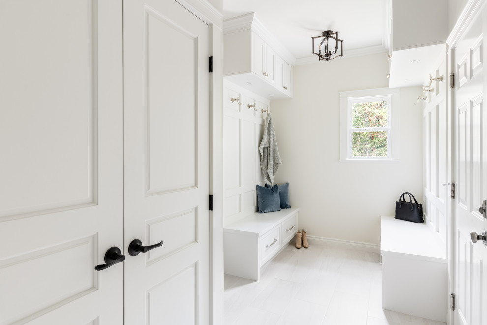 Inspiration for a mid-sized transitional porcelain tile and white floor mudroom remodel in Vancouver with white walls and a white front door