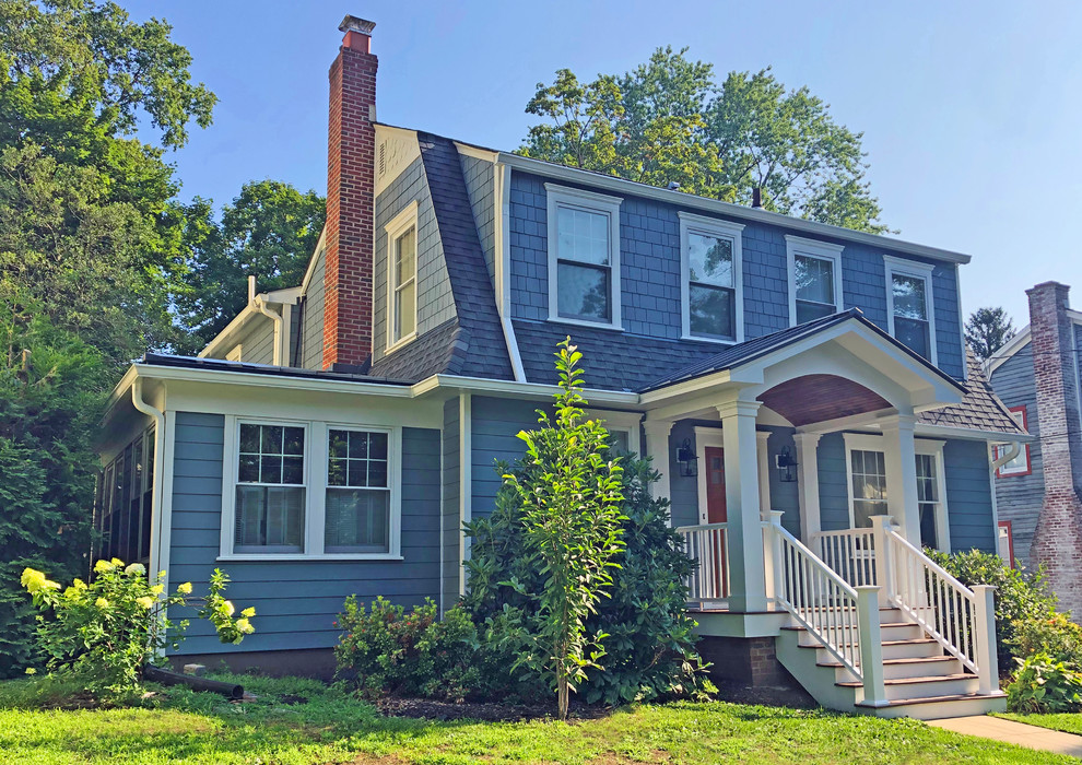Photo of a mid-sized traditional two-storey blue house exterior in Philadelphia with concrete fiberboard siding, a gambrel roof and a mixed roof.