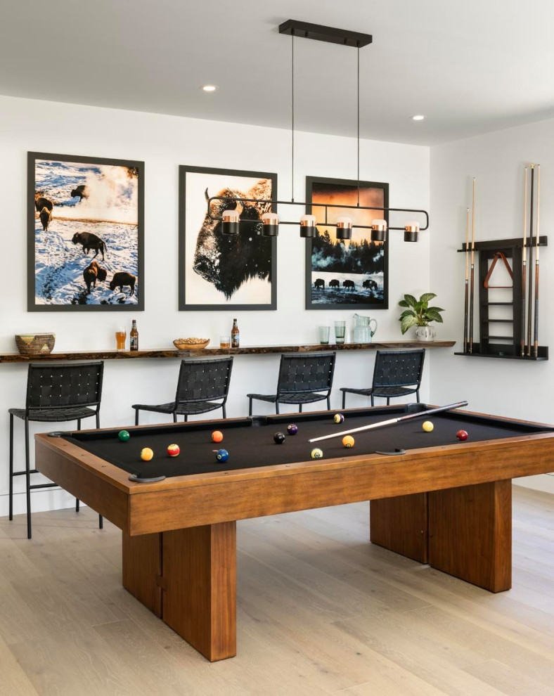 Large rustic games room in Denver with white walls and light hardwood flooring.