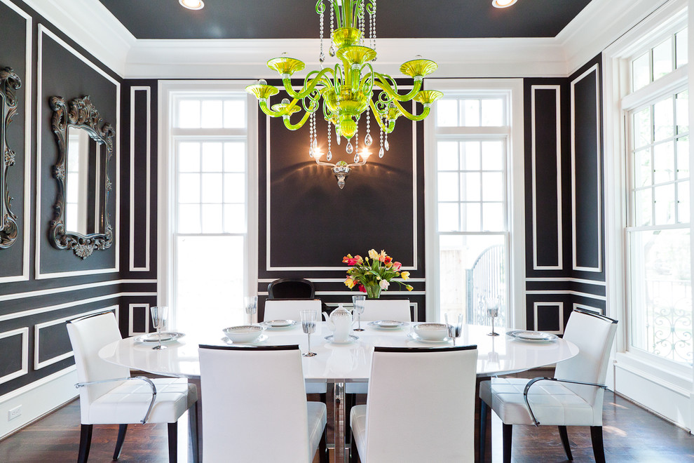 Contemporary separate dining room in Houston with black walls and dark hardwood floors.