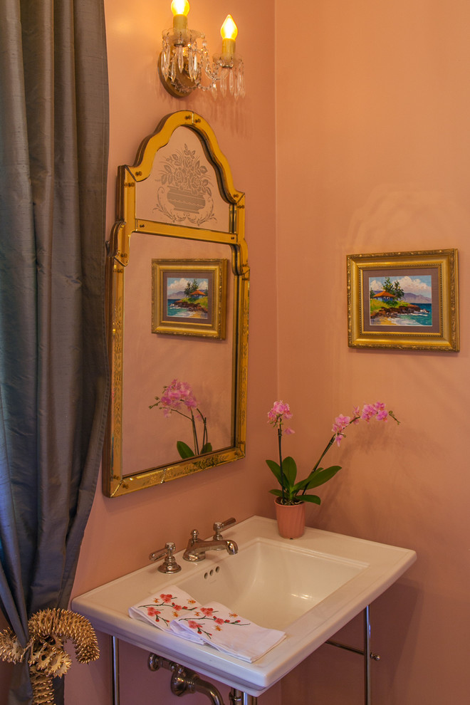 This is an example of a small traditional 3/4 bathroom in Austin with a pedestal sink, a freestanding tub, beige walls, marble floors, furniture-like cabinets, a shower/bathtub combo and a one-piece toilet.