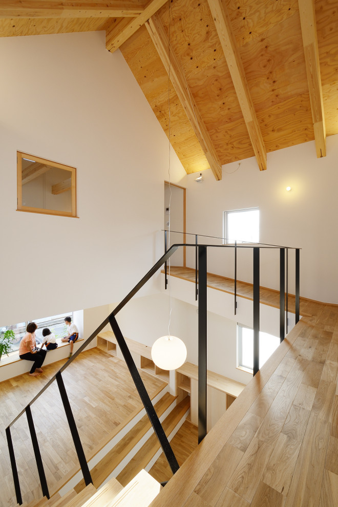 Foto de recibidores y pasillos escandinavos grandes con paredes blancas, suelo de madera en tonos medios, suelo marrón, madera y papel pintado