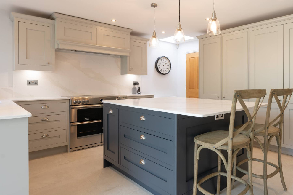 Design ideas for a large traditional u-shaped open plan kitchen in Hertfordshire with a built-in sink, shaker cabinets, grey cabinets, quartz worktops, white splashback, stainless steel appliances, an island and white worktops.