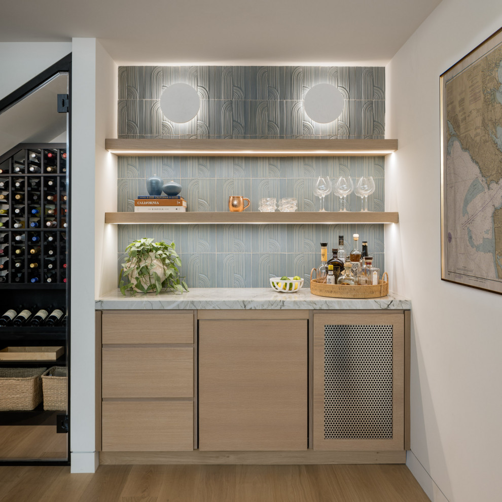 Example of a minimalist single-wall light wood floor and beige floor dry bar design in San Francisco with light wood cabinets, blue backsplash and white countertops