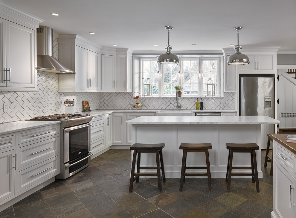 Design ideas for a large transitional l-shaped separate kitchen in Philadelphia with a farmhouse sink, recessed-panel cabinets, white cabinets, marble benchtops, white splashback, ceramic splashback, stainless steel appliances, slate floors, with island and multi-coloured floor.