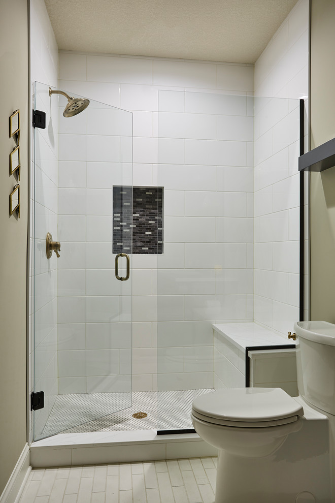 Inspiration for a mid-sized transitional 3/4 bathroom in Minneapolis with recessed-panel cabinets, black cabinets, an alcove shower, a two-piece toilet, white tile, ceramic tile, grey walls, terra-cotta floors, an undermount sink, engineered quartz benchtops, white floor and a hinged shower door.