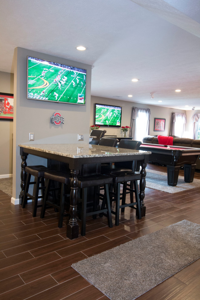 Photo of an expansive traditional enclosed family room in Other with a home bar, grey walls, ceramic floors, no fireplace and a built-in media wall.