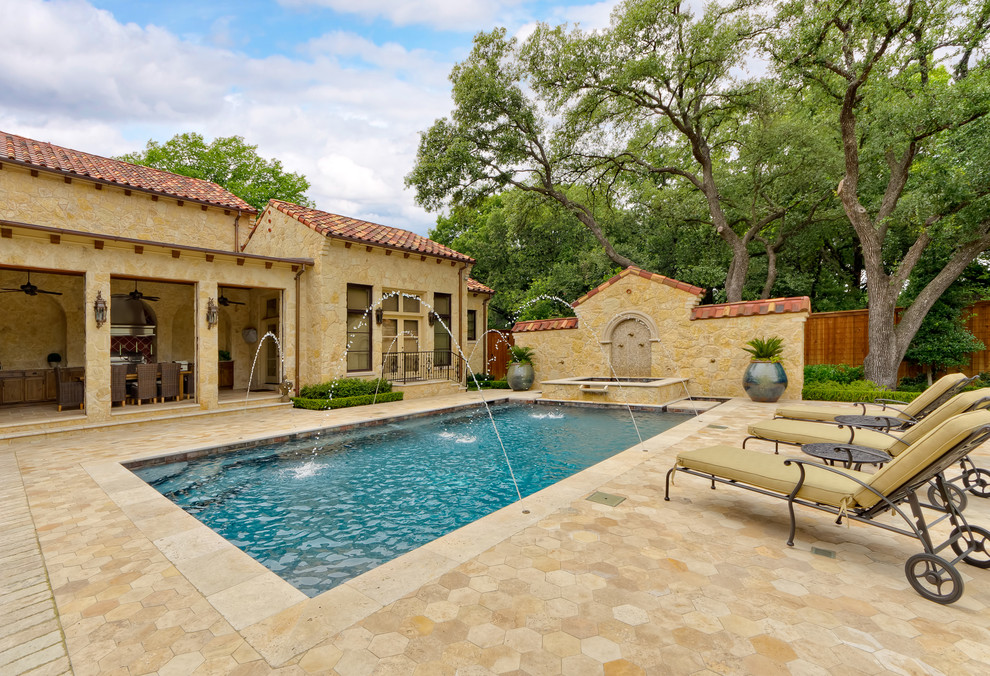 Inspiration for a mediterranean rectangular pool in Dallas with a water feature.