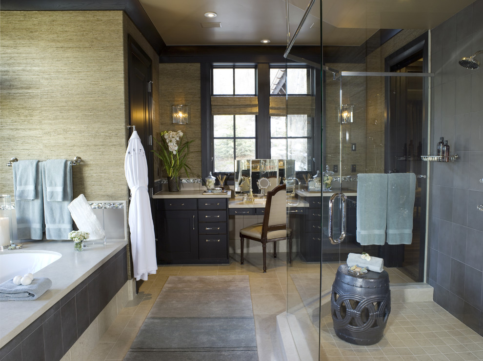 This is an example of a contemporary bathroom in Denver with shaker cabinets, dark wood cabinets, an undermount tub, a corner shower and gray tile.
