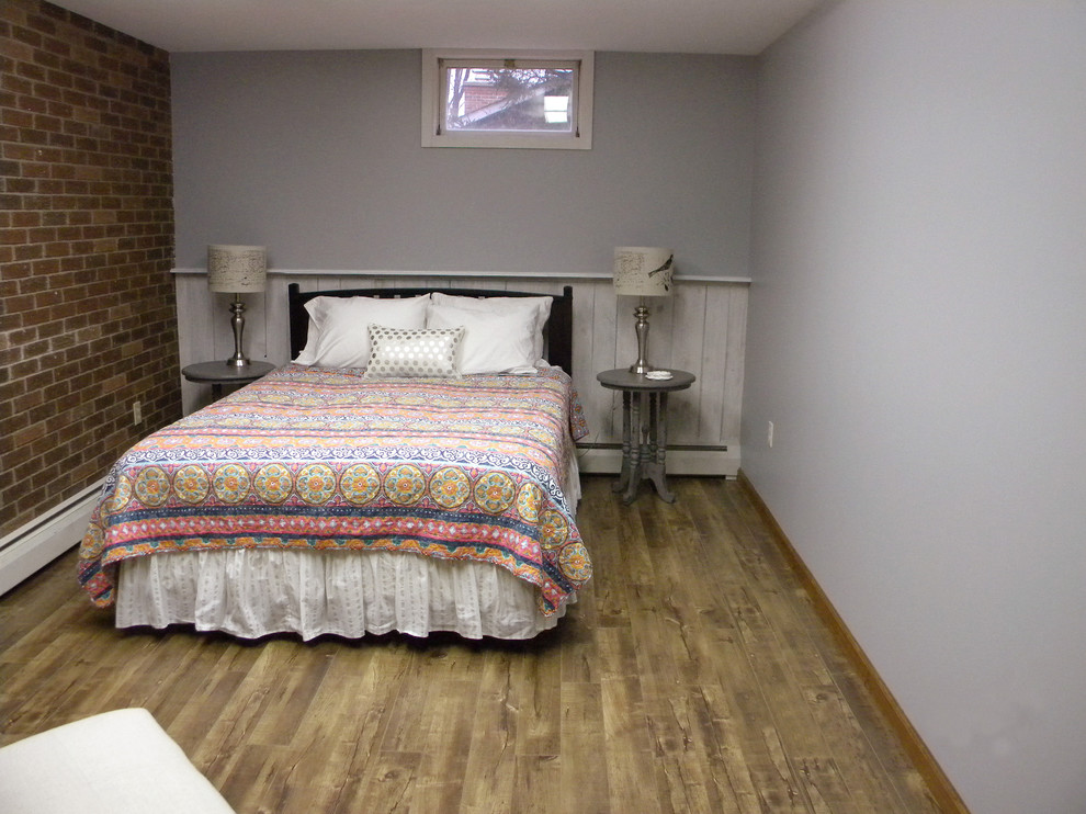 Inspiration for a mid-sized rustic underground ceramic tile basement remodel with gray walls