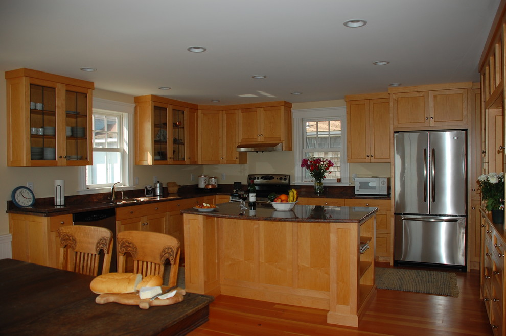 This is an example of a large traditional u-shaped eat-in kitchen in Boston with a single-bowl sink, shaker cabinets, light wood cabinets, granite benchtops, stone slab splashback, stainless steel appliances, light hardwood floors and with island.