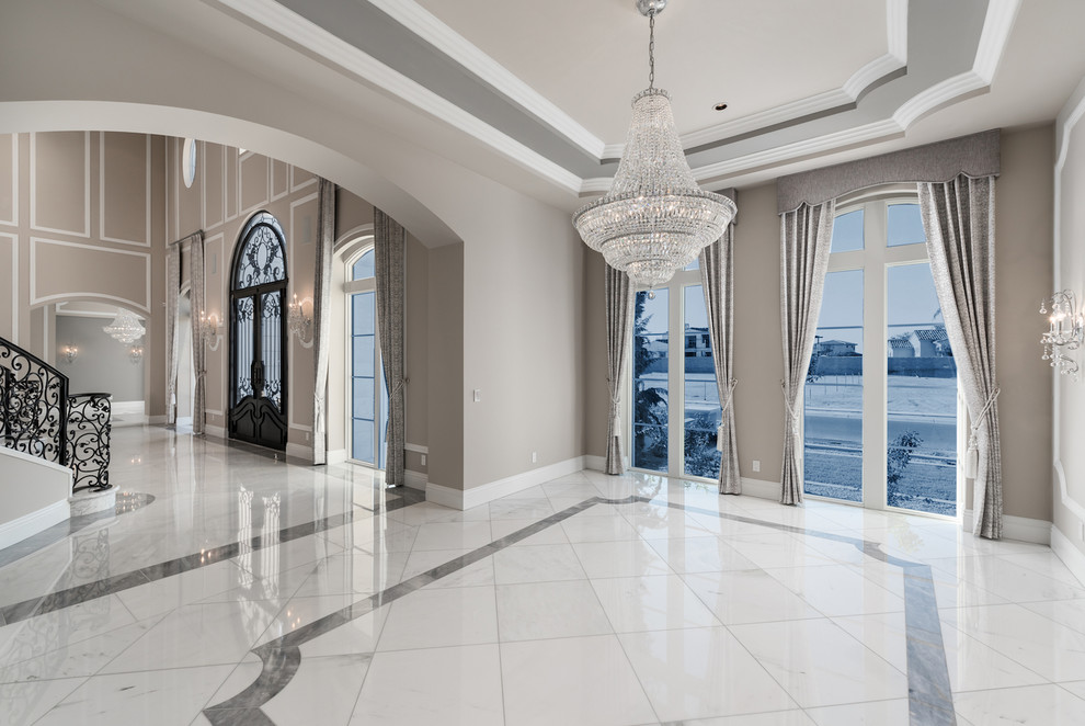 Design ideas for an expansive mediterranean foyer in Phoenix with grey walls, marble floors, a double front door, a metal front door, grey floor and recessed.