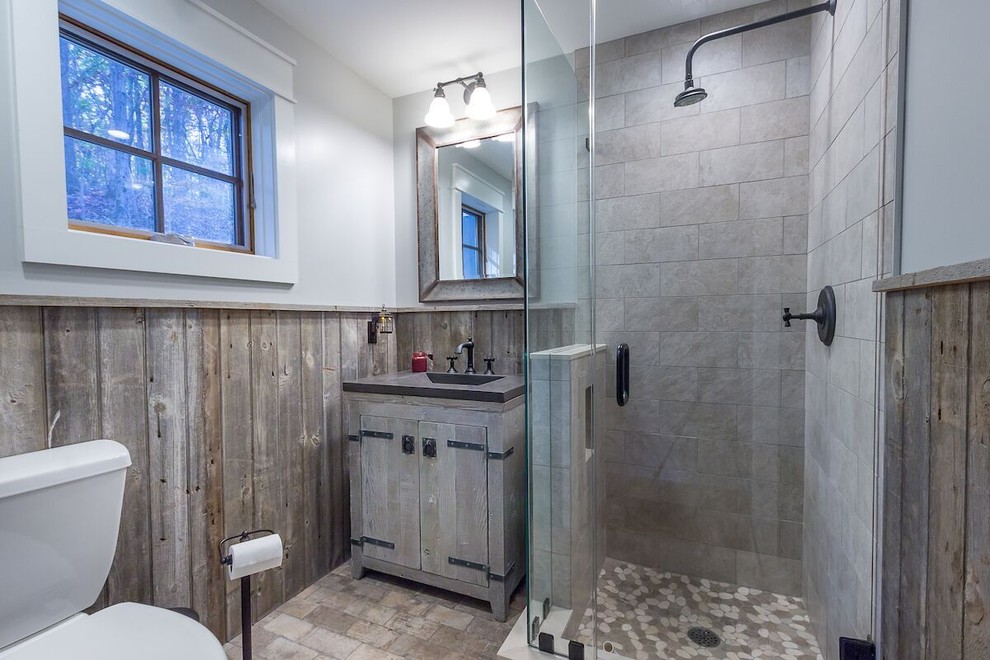 Photo of a mid-sized country 3/4 bathroom in Burlington with distressed cabinets, a corner shower, a two-piece toilet, beige tile, travertine, grey walls, ceramic floors, an integrated sink, zinc benchtops, beige floor and a hinged shower door.