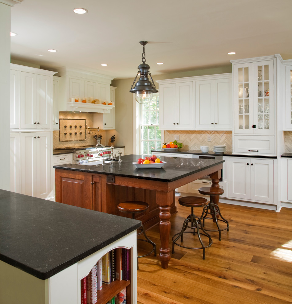 Inspiration for a traditional kitchen in Philadelphia with beaded inset cabinets, white cabinets, limestone benchtops, beige splashback and stainless steel appliances.