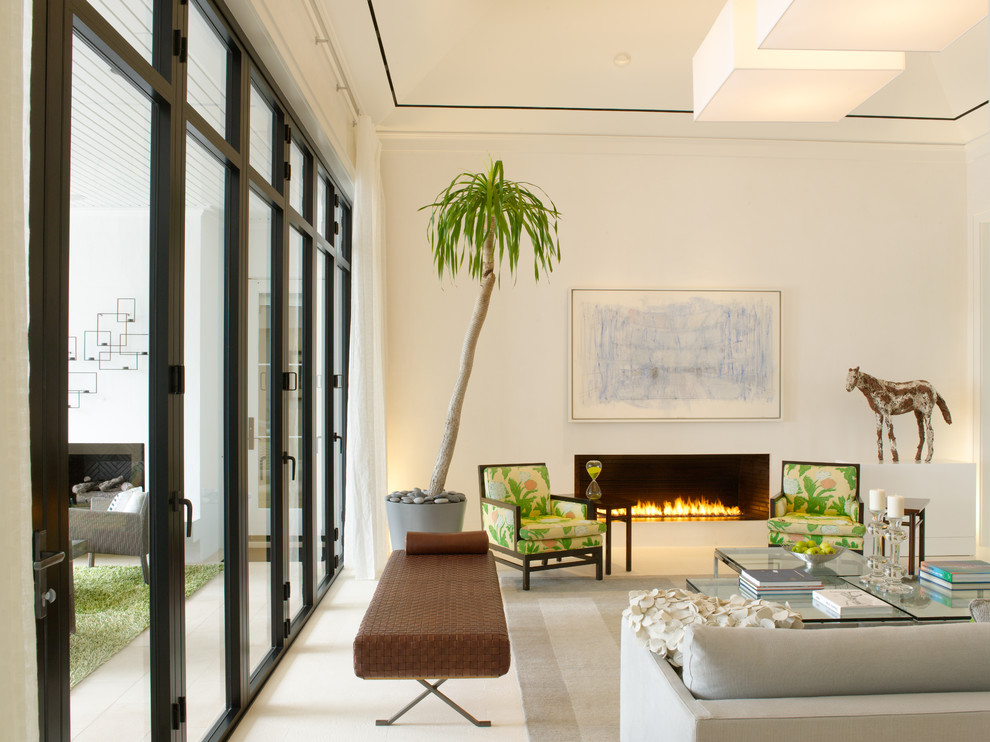 Design ideas for a tropical formal enclosed living room in Miami with white walls, a ribbon fireplace and no tv.