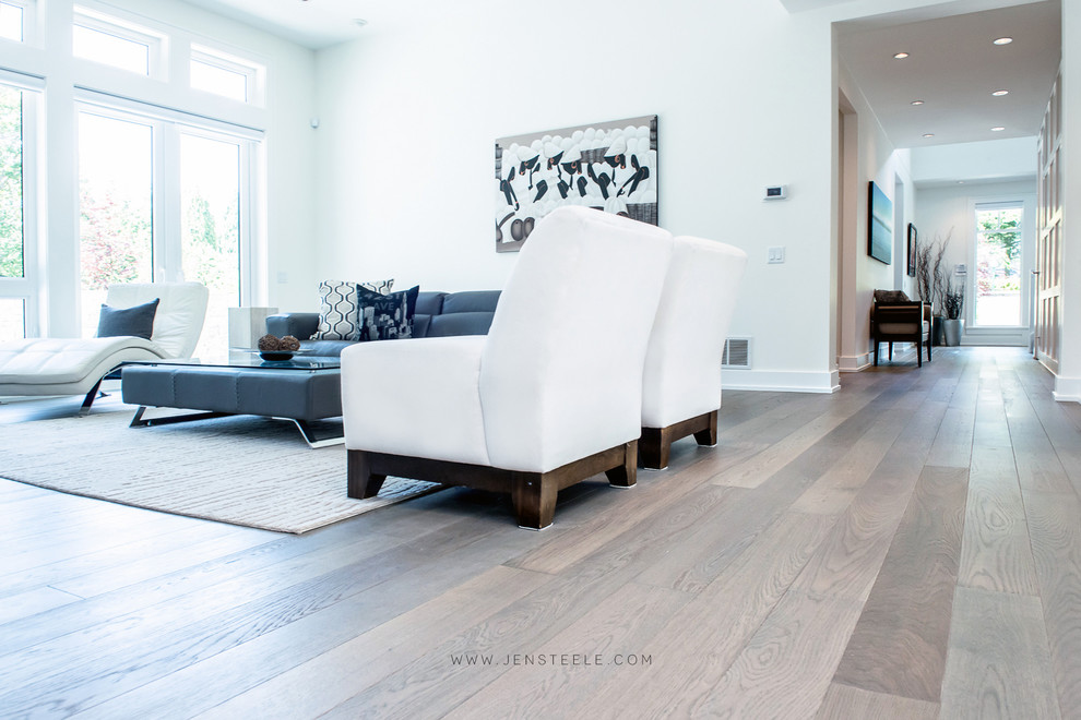 This is an example of a modern living room in Vancouver with light hardwood floors.