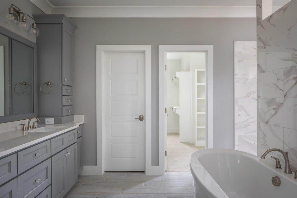 Photo of a mid-sized traditional master bathroom in Raleigh with beaded inset cabinets, grey cabinets, a freestanding tub, an open shower, white tile, grey walls, an integrated sink, grey floor, an open shower, white benchtops, a double vanity, a built-in vanity and coffered.