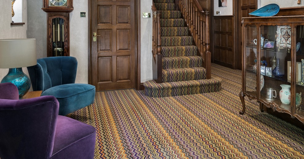 This is an example of a large traditional hallway in Berkshire with grey walls, carpet and multi-coloured floor.