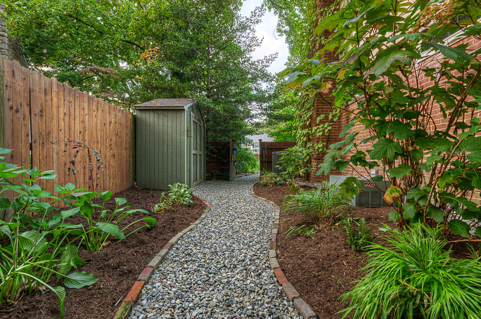This is an example of a side yard garden in Wilmington with gravel.