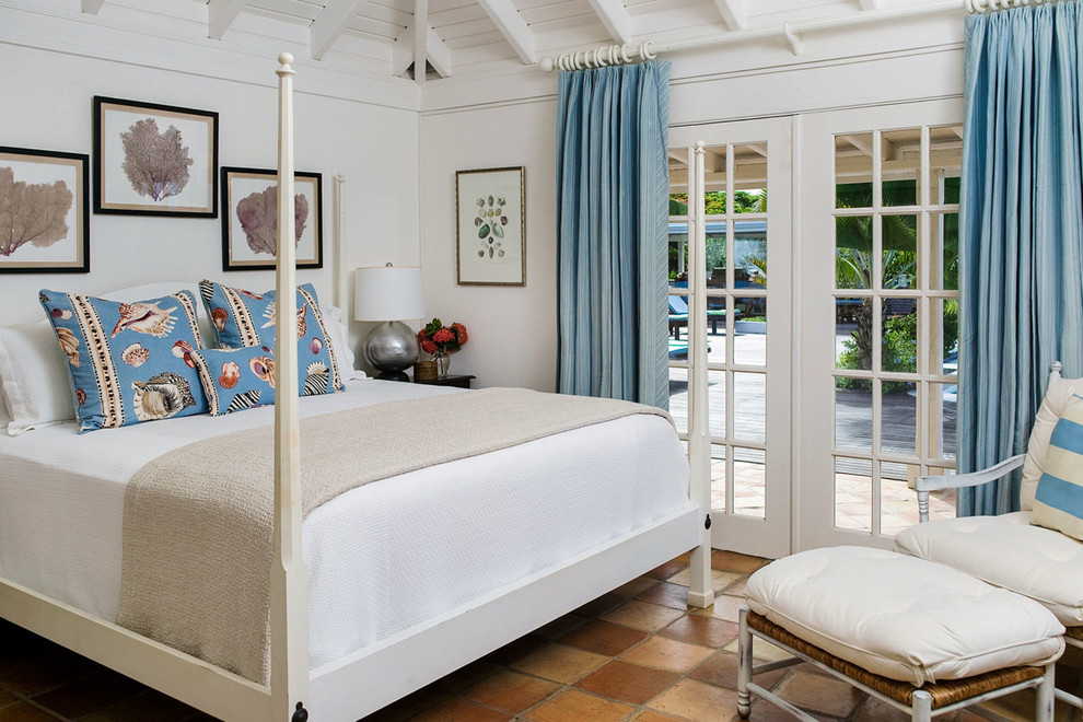 Photo of a tropical bedroom in Atlanta with white walls.